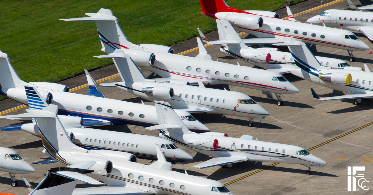 Part 91 vs Part 135 Business jets parked on an airport ramp, representing Part 91 vs. Part 135 staffing needs and crew requirements in business aviation.